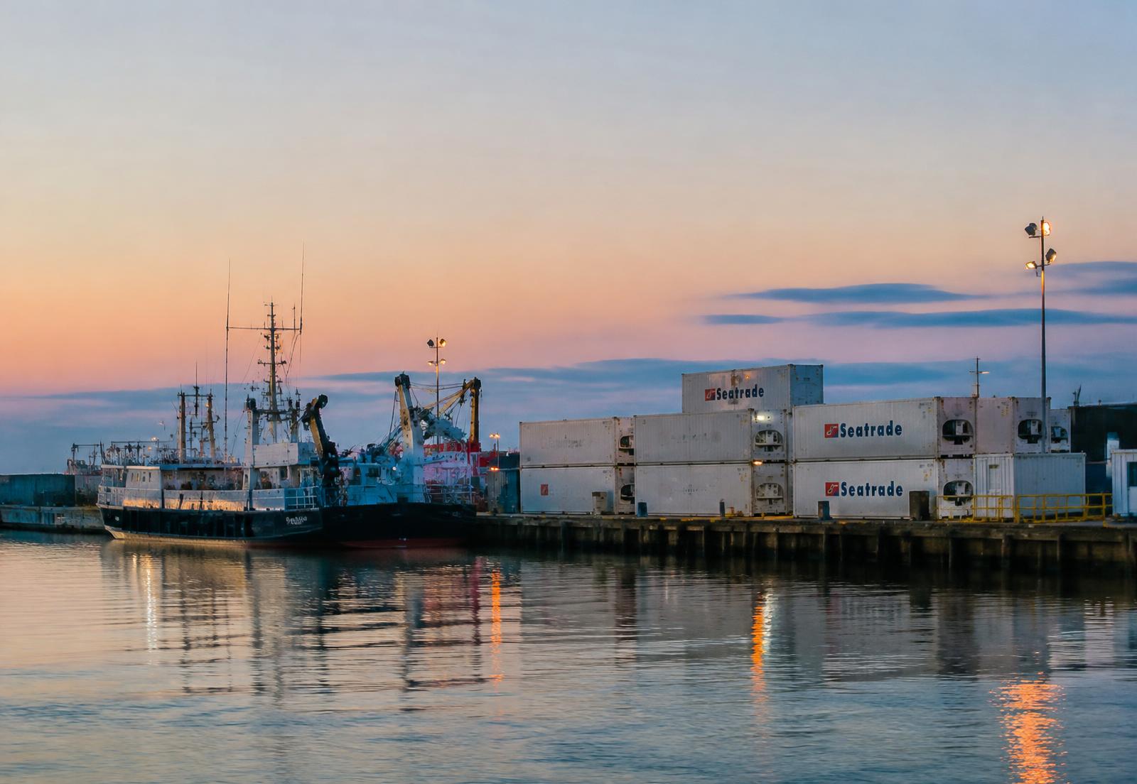 Fishing port at dawn with refrigerated containers